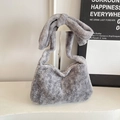 Grey faux fur bucket bag featuring a stylish knotted shoulder strap and soft texture - Gray