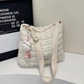 Dettaglio della borsa trapuntata bianco panna con tracolla larga e ciondolo a coniglietto - Bianco Sporco Con Pendente
