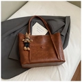 Detail of dark brown leather tote bag with vintage texture and cute bunny charm pendant - Brown with Pendant