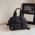 Versatile black commuter handbag with multiple zipper pockets and brown leather handle wrap - Black