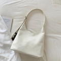 Close-up of creamy white hobo bag on white fabric with a cute brown bear charm - White With Pendant