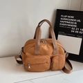 Caramel nylon multi-pocket travel handbag with adjustable shoulder strap and silver zippers - Brown