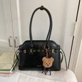Détail de la texture du cabas en cuir ciré noir avec charm ours et finitions dorées - Noir Avec Pendentif