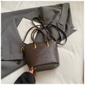 Detail of dark brown tote bag showing leather texture and gold protective rivets - Coffee without Pendant