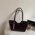 Detail of dark brown leather tote with wavy U-shaped top and colorful beaded charm - With Pendant / Coffee