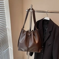 Dark brown leather drawstring bucket bag with adjustable strap and textured finish - Coffee without Pendant