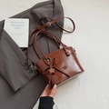 Chic dark brown glossy leather bucket bag with top handle and star charm ornament - Brown