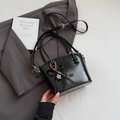 Glossy black bucket handbag with beaded charms and bow on structured crossbody bag - Black