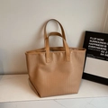 Close-up of crocodile embossed texture on large beige tote bag with neat stitching details - Khaki
