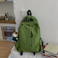 Detail view of grass green waterproof nylon backpack featuring a cute panda plush charm - With Charm / Green