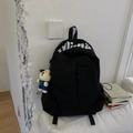 Detail of black canvas backpack with white letter print and cute puppy plush charm - With Charm / Black