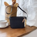 Detail of black pleated crossbody bag with stylish beaded charm on a baguette bag - Black