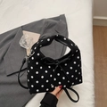 Polka dot crossbody bag in black and white with a black bow detail and round shape - Black
