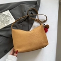 Brown suede hobo handbag with gold rings and plush charms on a grey blazer background - Brown (With Pendant)