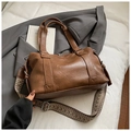 Detail of brown PU leather bag with textured surface and geometric woven shoulder strap - Large / Brown