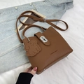 Brown lychee leather bucket bag with silver twist lock and cute bear charm pendant - Brown