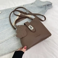 Coffee brown pebbled leather bucket bag with dog charm and adjustable strap - Brown