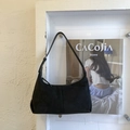 Close-up of black suede hobo bag with matte finish and silver zipper hardware details - Black