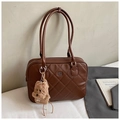 Close-up of quilted dark brown tote bag with classic rhombus pattern and plush puppy charm - Brown Small With Pendant