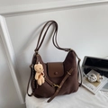 Detail of vintage brown suede shoulder bag with leather strap and plush bear charm - Coffee (With Pendant)