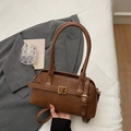 Minimalist brown PU leather underarm bag with gold buckle on casual grey blazer background - Brown