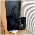 Detail of black quilted tote bag texture with cute bear and star plush charms - Black With Pendant