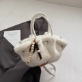 White plush bucket bag with wooden bead charm and round top handles in fluffy faux fur - With Charm / White