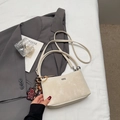 Detail of minimalist beige bucket bag with creative leopard bear charm on gray blazer - Off-white With Pendant