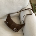 Detail of dark brown suede crescent shoulder bag with decorative silver buckles - Brown