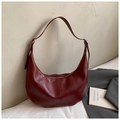 Detail of dark red crescent shoulder bag featuring premium pebbled texture and stitching - Burgundy