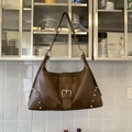 Detail of vintage brown leather bag with silver buckle and metal rivets decoration - Brown