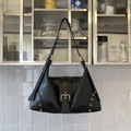 Detail of black Y2K shoulder bag featuring silver buckle strap and rivet decorations - Black