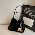 Close-up of fluffy black plush handbag with stylish leather strap and cute bear charm - Black With Pendant
