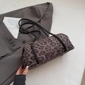 Cylindrical leopard print shoulder bag with black straps and golden metal rings - Gray