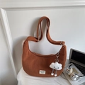 Close-up of brown corduroy crescent bag with adjustable strap and cute cloud pendant - With Pendant / Brown