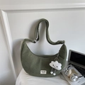 Close-up of grass green corduroy crescent bag with metal buckle and plush charm - With Pendant / Green