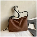 Dark brown suede hobo bag with wide black leather strap and gold buckle detail - Brown