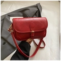 Detailed view of retro red leather shoulder bag with vintage gold buckle and strap - Red