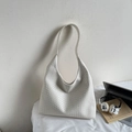 Detail of white woven texture on minimalist hobo bucket bag in a modern lifestyle setting - Off-white