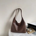 Detail of brown woven hobo bag with office props like laptop and headphones - Coffee