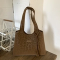 Detailed close-up of brown leopard print tote bag with tassel and fashion logo tag - Brown