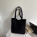 Black corduroy tote bag for women featuring long straps and minimalist brand label - Black