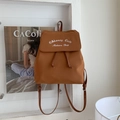 Detail view of caramel brown canvas backpack with drawstring and brand embroidery - Caramel color