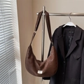 Minimalist brown crescent hobo bag with contrast stitching and branding shown on metal hanger - Coffee (No Pendant)