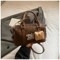 Detail of vintage brown Boston bag with letter embroidery and cute biscuit charm - Coffee Leopard With Pendant