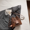 Stylish bucket bag featuring leopard print fabric with brown leather trim and shoulder strap - Brown No Pendant