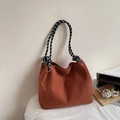 Close-up of corduroy tote bag with rust red texture and checkered rope shoulder strap - Orange Red