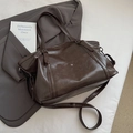 Detail of vintage brown oil wax leather tote bag with dual handles and metal rivets - Brown
