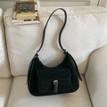 Detail showing the suede texture and silver metal buckle on black underarm bag - Black