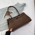 Brown vintage suede tote bag with long shoulder straps on a cozy white fabric background - Brown